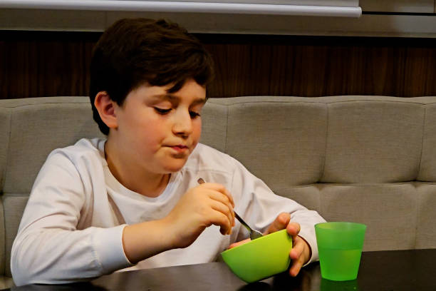 istock 10 year old child having dinner at home 1967906669