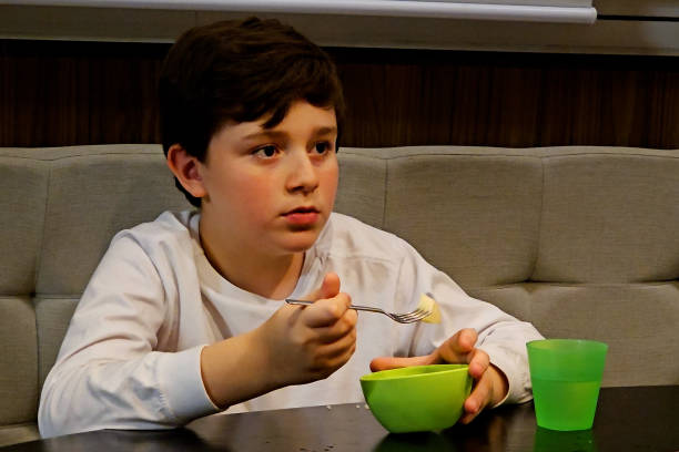 istock 10 year old child having dinner at home 1967906683