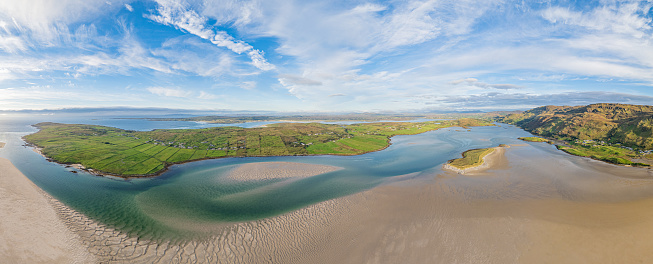 Top view of the crescent-shaped Maitai Bay and sandy beach, afternoon​ light