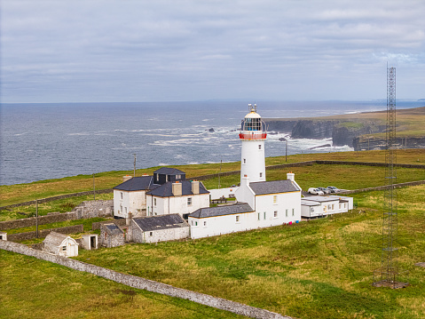 The Loop Head Lighthouse is located in County Clare, Ireland. It is situated on the Loop Head Peninsula, overlooking the Atlantic Ocean. The lighthouse offers stunning views of the rugged coastline and is a popular tourist attraction.