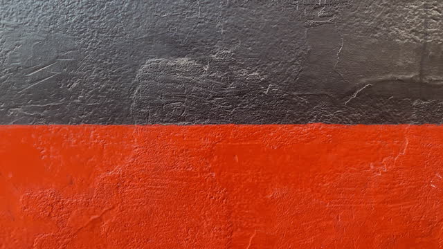 Concrete wall painted in black and red colors