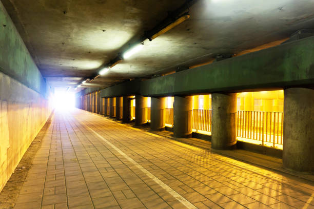 istock Tunnel background. Road under the bridge. Empty asphalt road. Metro road passage. 1967956034