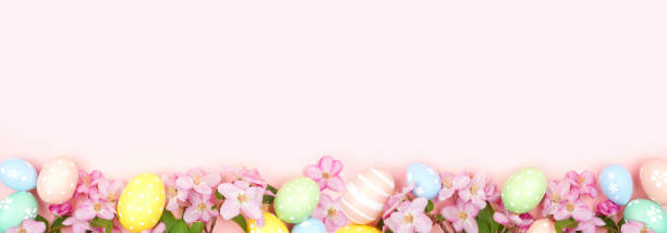 istock Easter eggs and cherry blossom flowers bottom border against a soft pink banner background 1967976348