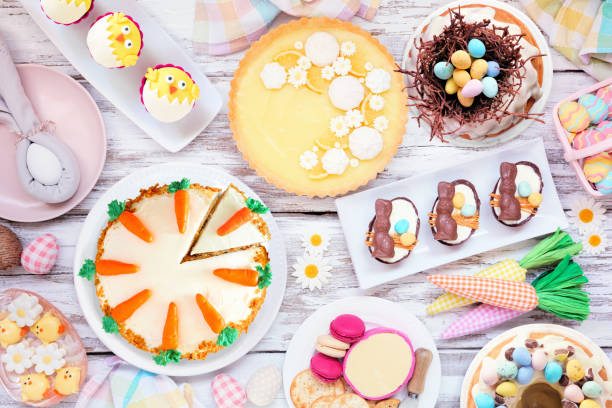 istock Easter or spring dessert food table scene. Top down view over a white wood background. 1967977960
