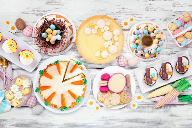istock Easter or spring dessert food table scene. Overhead view on a white wood background. 1967977961