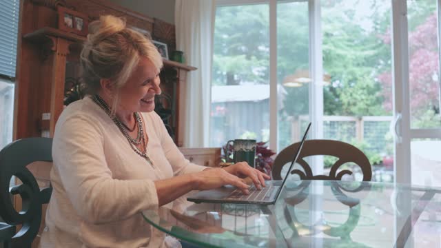 Senior Woman Shopping Online On Laptop Computer