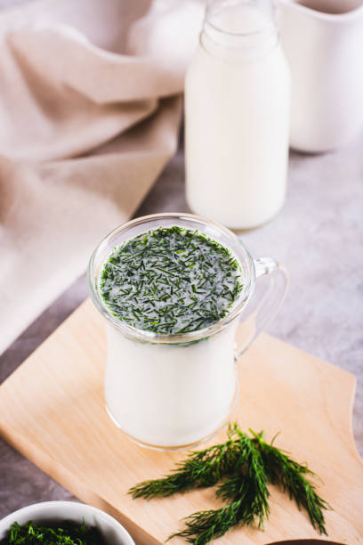 istock Glass with fresh Turkish ayran with dill and greens on the table vertical view 1967994166
