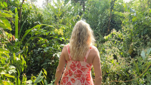 istock Mature woman walks through jungle 1967996261