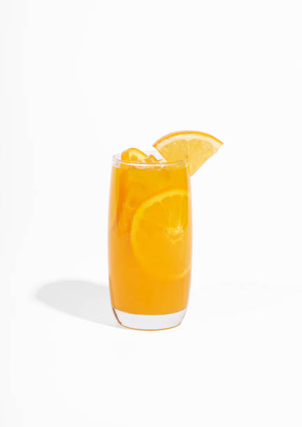glass of 100% orange juice with orange slices fruits isolated on white background. cooling beverage summer drink - isolated on white orange juice ripe leaf foto e immagini stock