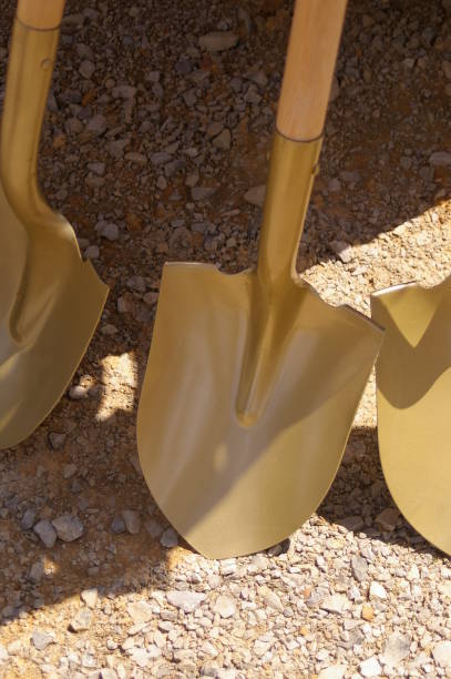 Close up of shovels painted gold for a ceremony to break ground for a new construction site