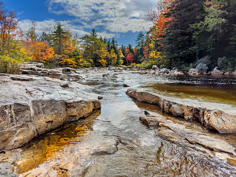 Shallow and rocky Swift River near the Rocky Gorge Scenic Area in Autumn. Kancamagus Highway, New Hampshire