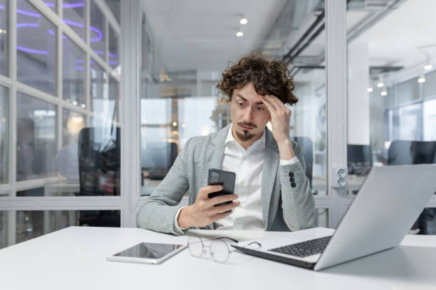 istock Exhausted young businessman in office feeling overwhelmed and stressed 1968095586