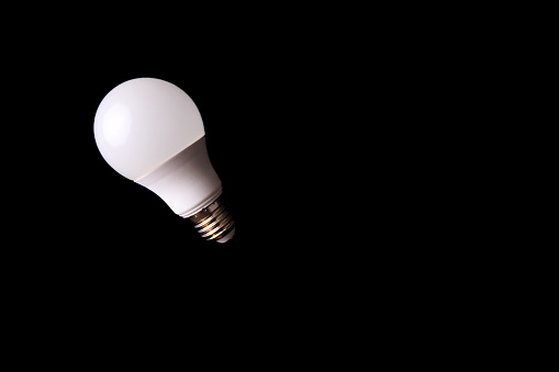 An E-27 Edison Screw light bulbs place on a black background and shot from above. Studio shot. No people.