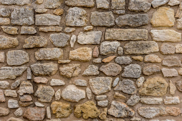 istock Old stone wall with natural stones. 1968120429