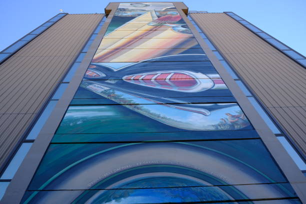Crazy mural of some cars on the side of a building in downtown Lafayette Louisiana. The artist signature is in the painting.