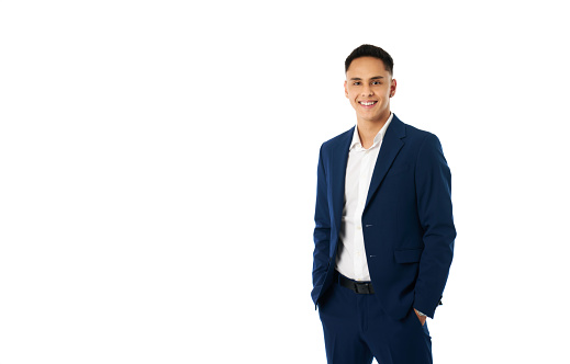 Portrait of a young Latino business entrepreneur in formal suit looking at the camera smiling isolated on a white background