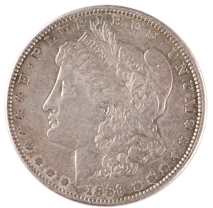Close up of a Morgan Silver Dollar, US currency obverse side, isolated on white.