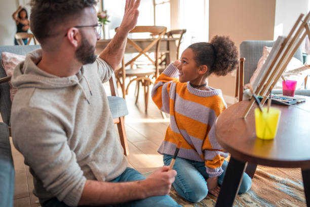 istock Father Daughter High Five at Home 1968244545