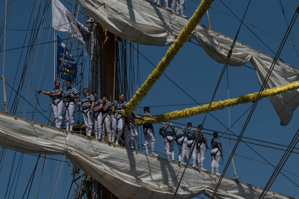 Sailors standing on rig of a three-master in Cadiz Harbor leaving for mexico, Gran Regata Cadiz 2023