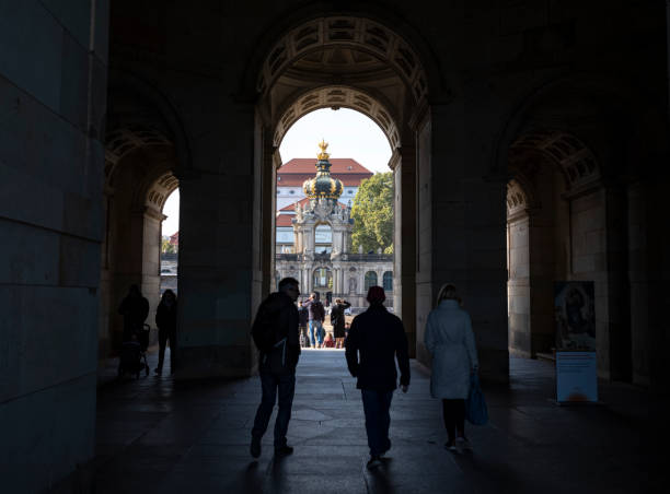 A view of tourists entering the gates of Dresden Castle in Dresden Germany. For almost 400 years, the castle was the residence of the electors (1547–1806) and kings (1806–1918) of Saxony from the Albertine House of Wettin as well as Kings of Poland (1697–1763). It is known for the different architectural styles employed, from Baroque to Neo-renaissance. Most of the castle was reduced to a roofless shell during 13 February 1945 bombing of Dresden in World War II. Three rooms of the Green Vault were destroyed. However, the collections survived, having been moved to safety at Königstein Fortress in the early years of the war.