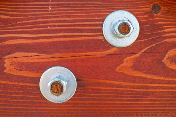 Close-up a painted pinewood board with screws.