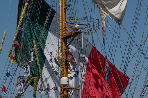 Sailors standing on rig of a three-master in Cadiz Harbor leaving for mexico, Gran Regata Cadiz 2023