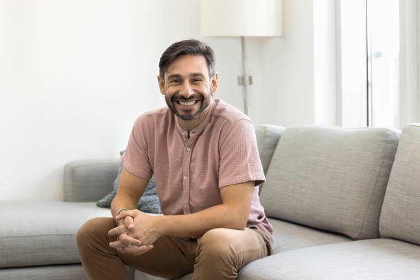istock Happy handsome middle aged man sitting on comfortable sofa 1968338462