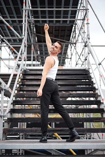Gay man singer ready to perform on an outdoor stage.