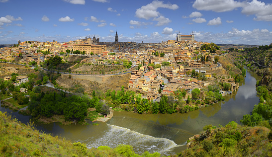 Toledo, Castile-La-Mancha, Spain - old town cityscape at the Alcazar. Toledo is World heritage site by Unesco - The picturesque panorama of the ancient city Toledo on the Tajo River.