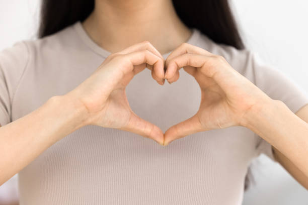 istock Young woman showing hand heart shape at camera 1968425556