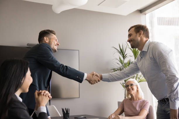 istock Cheerful business partners men starting cooperation, getting partnership 1968458761