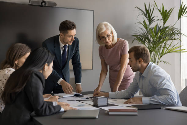 istock Busy diverse company managers reviewing accounting statistic paper reports 1968462255