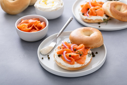 Plain bagel with salmon and cream cheese with fresh dill and capers for breakfast
