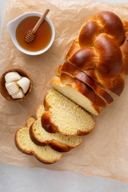 Freshly baked hallah sliced with butter and honey