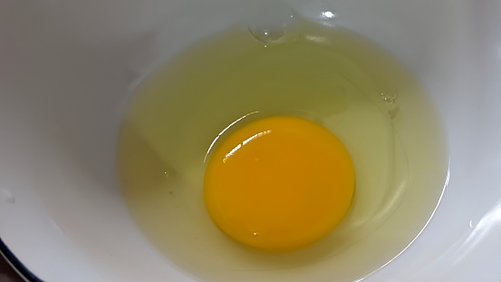closeup of raw eggs in a bowl