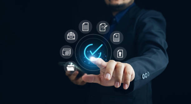 istock Businessman using smartphone with virtual correct sign or tick mark with document icon for approve quality assurance and guarantee concept, online approve paperless and quality assurance concept. 1968555803