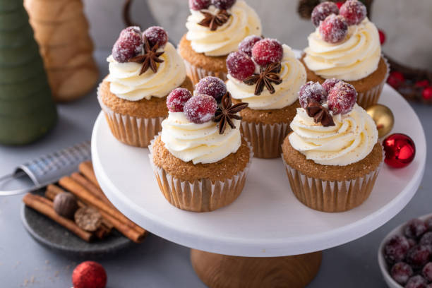 istock Spiced cinnamon and cranberry cupcakes topped with sugared cranberries for Christmas or Thanksgiving 1968568455