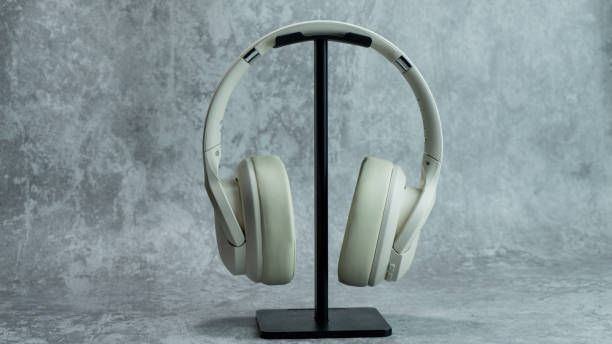 istock White headphones on a gray table with concrete texture 1968685741