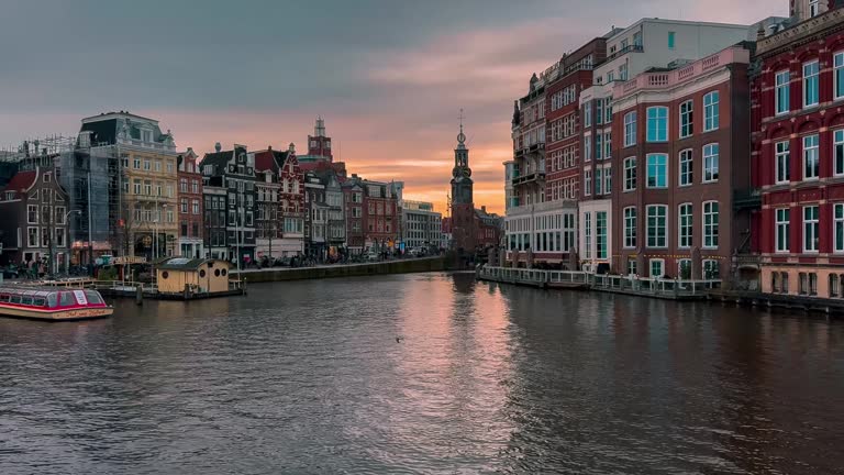 Traditional old narrow houses boats and canals in Amsterdam, Netherlands, Europe, January 20, 2024