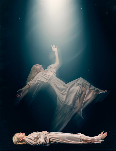 istock Woman Experiencing Astral Projection as Her Spirit body Floats Toward Light 1968734237