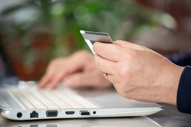 istock Asian middle-aged man's hands entering credit card information 1968745454