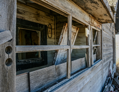 An obsolete building still shows character in its antique window settings.