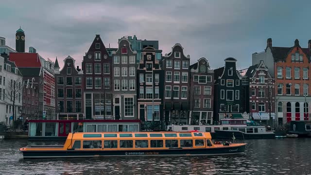 Traditional old narrow houses boats and canals in Amsterdam, Netherlands, Europe, January 20, 2024