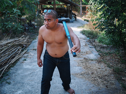 Thai man holding sledgehammer