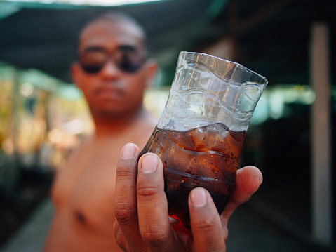 brown man drink cola