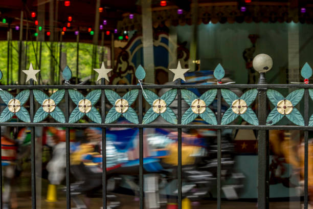 A dynamic shot capturing the spinning motion and vibrant lights of a vintage carousel at the Berlin Christmas Market. The blurred details and golden glow evoke a sense of excitement and nostalgia, highlighting the festive atmosphere