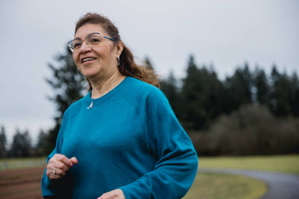 istock Hispanic Senior woman exercising at a park 1968803337