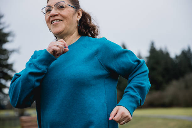 istock Hispanic Senior woman exercising at a park 1968803339