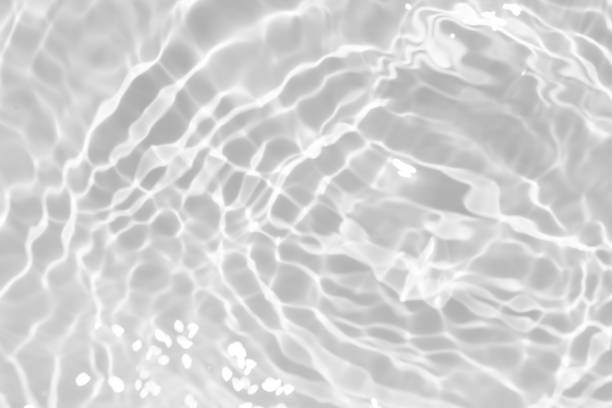 istock White water with ripples on the surface. Defocus blurred transparent white colored clear calm water surface texture with splashes and bubbles. Water waves with shining pattern texture background. 1968805500