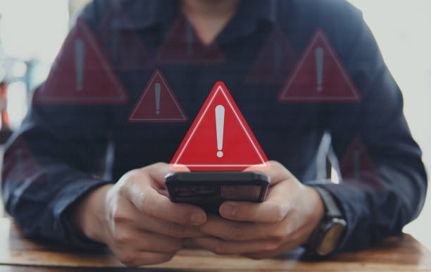 istock Emergency warning alert alarm on Smartphone, Data network protection, Virus alarm with people using application on smartphone. 1968805931